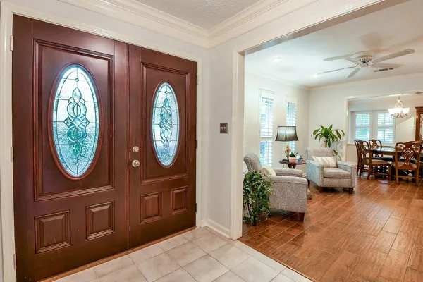 a living room with furniture a mirror and a large window