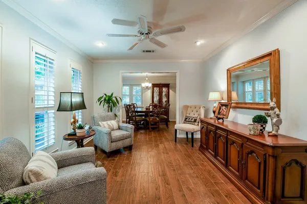 a living room with furniture wooden floor and a chandelier