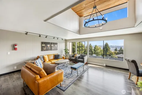 a living room with furniture and a floor to ceiling window