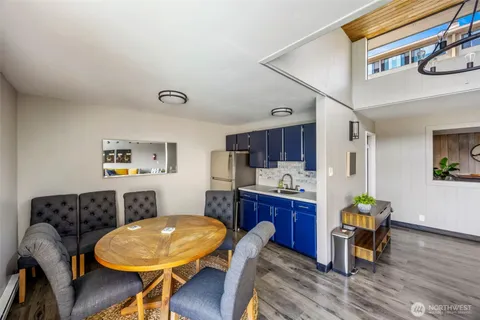 a living room with furniture a rug and white walls