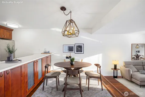 a living room with furniture a window and a chandelier
