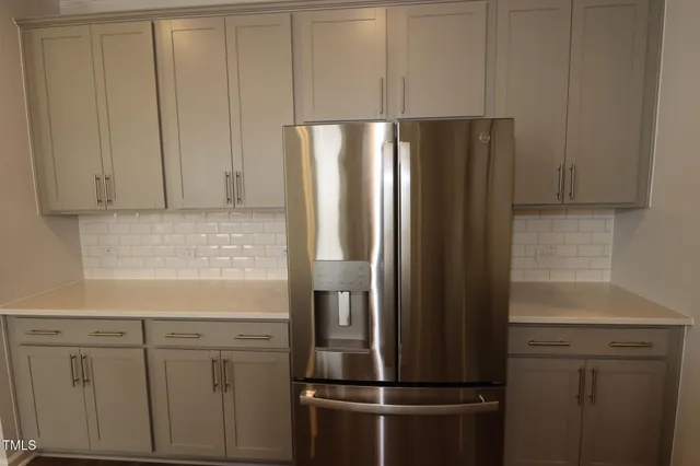 a stove top oven sitting inside of a kitchen