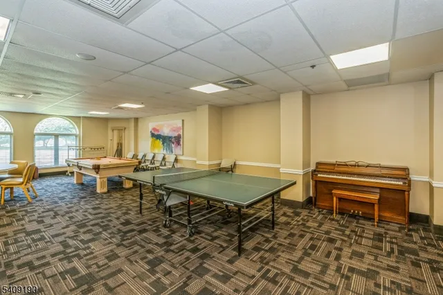 a bathroom with a bathtub shower sink vanity and toilet