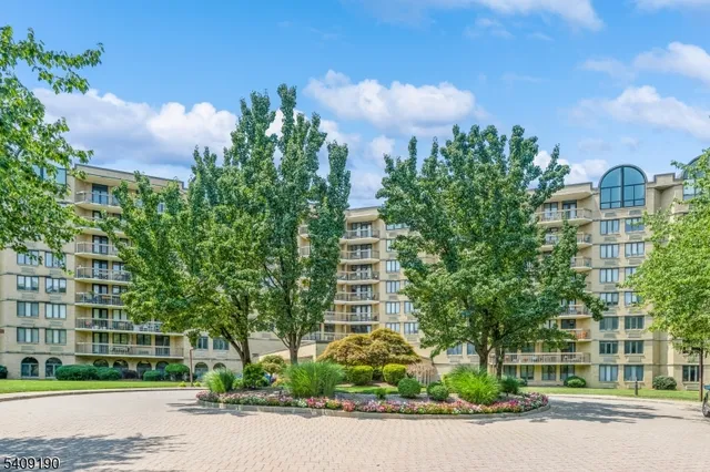 a front view of a multi story building with yard