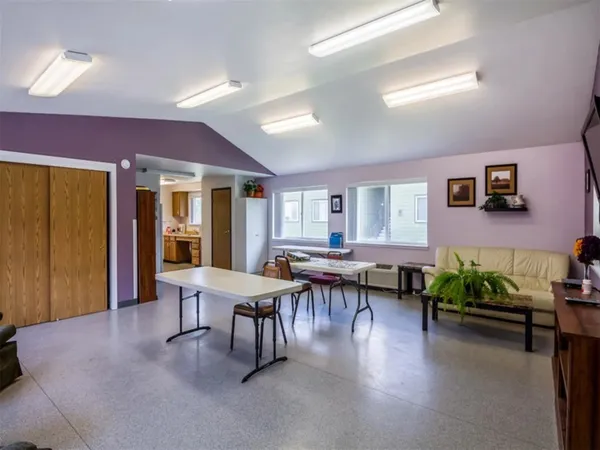a dining room with furniture and wooden floor