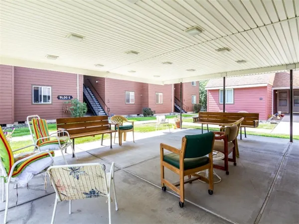 a view of a patio with a table and chairs