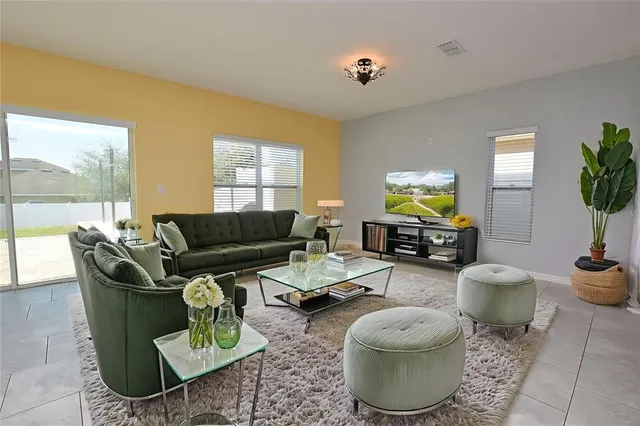 a living room with furniture and a large window