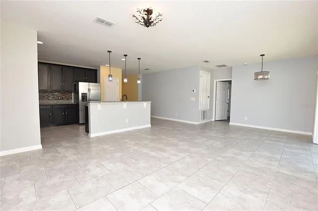 a view of a kitchen with a sink and a refrigerator