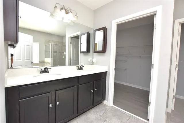 a bathroom with a sink vanity and mirror