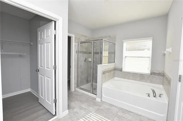 a bathroom with a bathtub and a shower