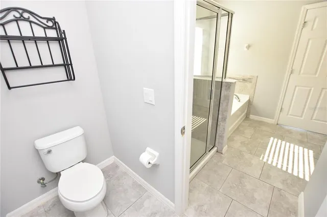 a white toilet sitting next to a bathroom sink