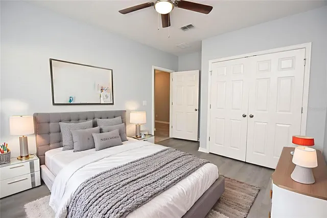 a bedroom with a bed and a chandelier