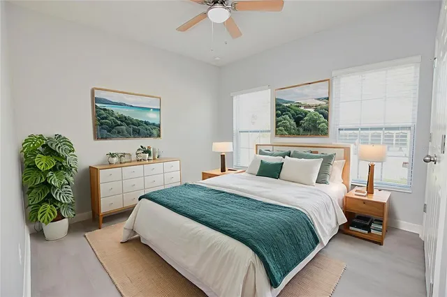 a spacious bedroom with a bed and a chandelier
