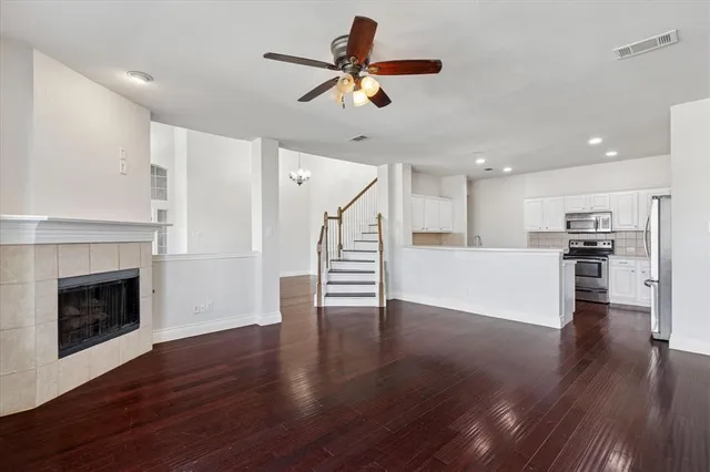 a view of a kitchen with wooden floor and a ceiling fan