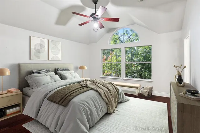 a bed sitting in a bedroom next to a window