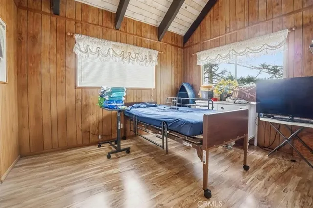 a room with a window wooden floor and furniture