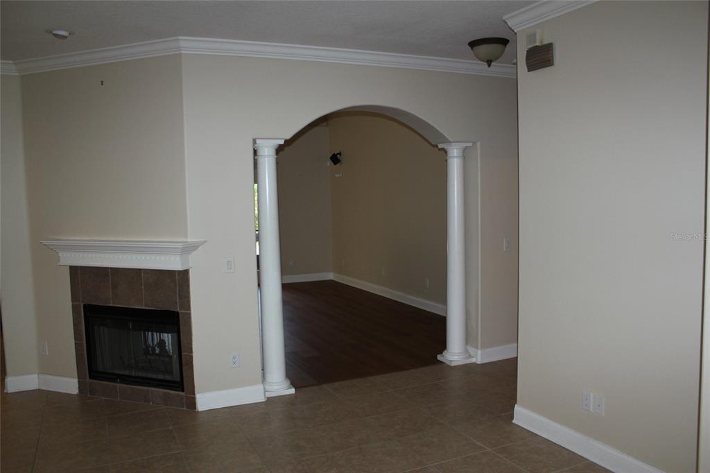 6833 Dolce Way Orlando, FL 32819 - Photo 11 of 28 a view of empty room with fireplace
