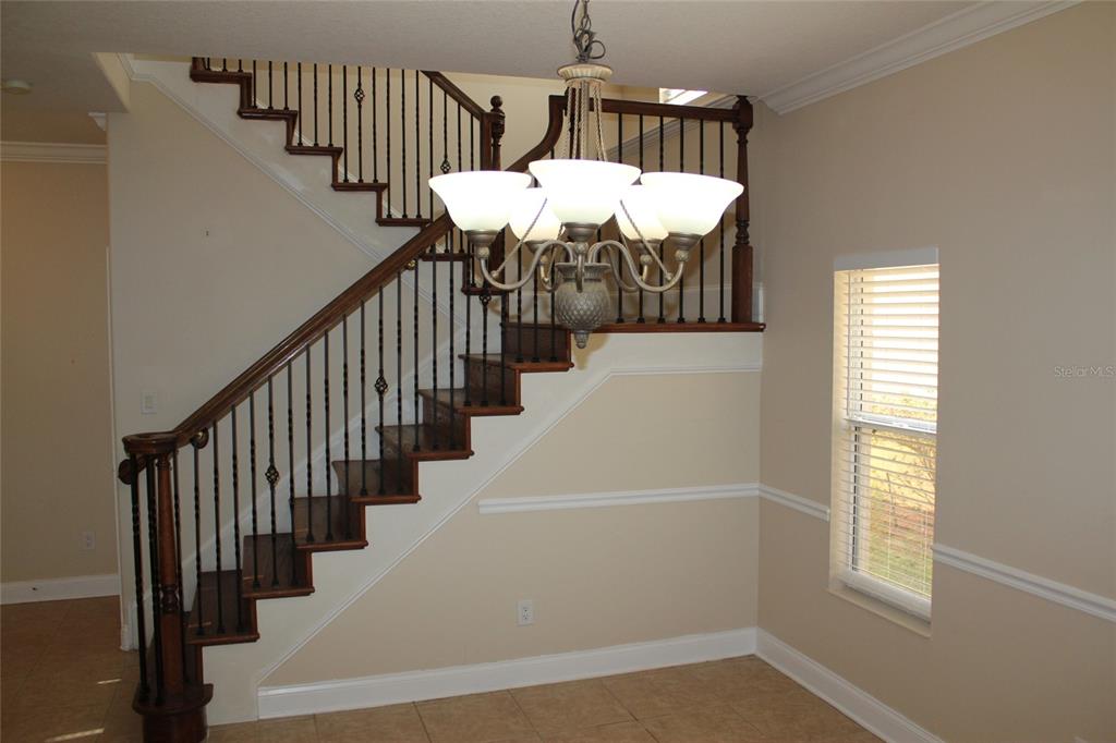 6833 Dolce Way Orlando, FL 32819 - Photo 16 of 28 a view of entryway and hall with wooden floor