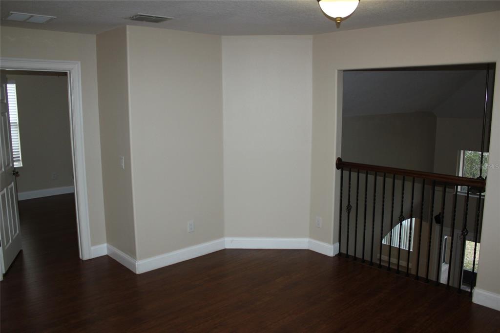 6833 Dolce Way Orlando, FL 32819 - Photo 18 of 28 a view of a hallway with wooden floor