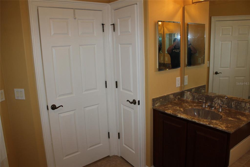 6833 Dolce Way Orlando, FL 32819 - Photo 24 of 28 a bathroom with a granite countertop sink and shower