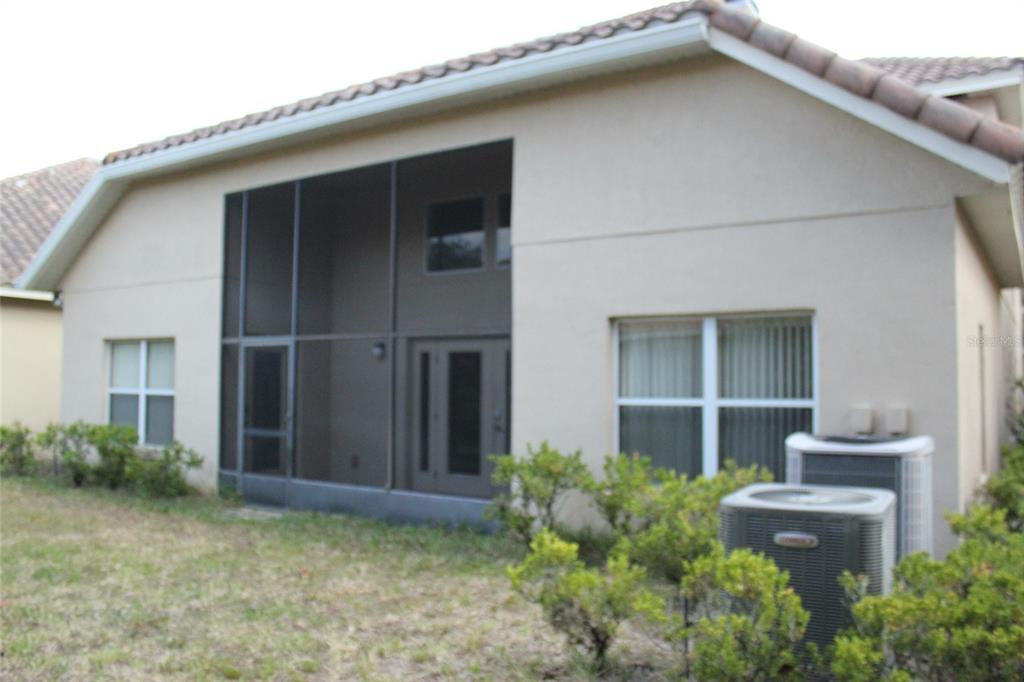 6833 Dolce Way Orlando, FL 32819 - Photo 3 of 28 a house with a small yard and plants