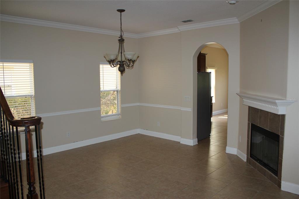 6833 Dolce Way Orlando, FL 32819 - Photo 7 of 28 a view of empty room with windows and fireplace