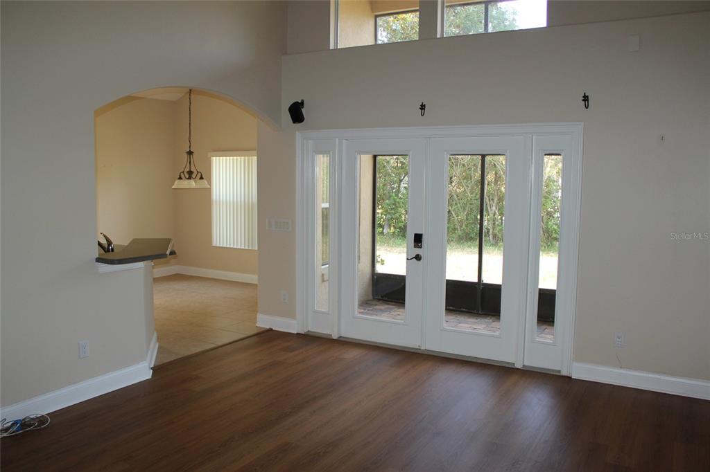 6833 Dolce Way Orlando, FL 32819 - Photo 9 of 28 wooden floor in an empty room with a window