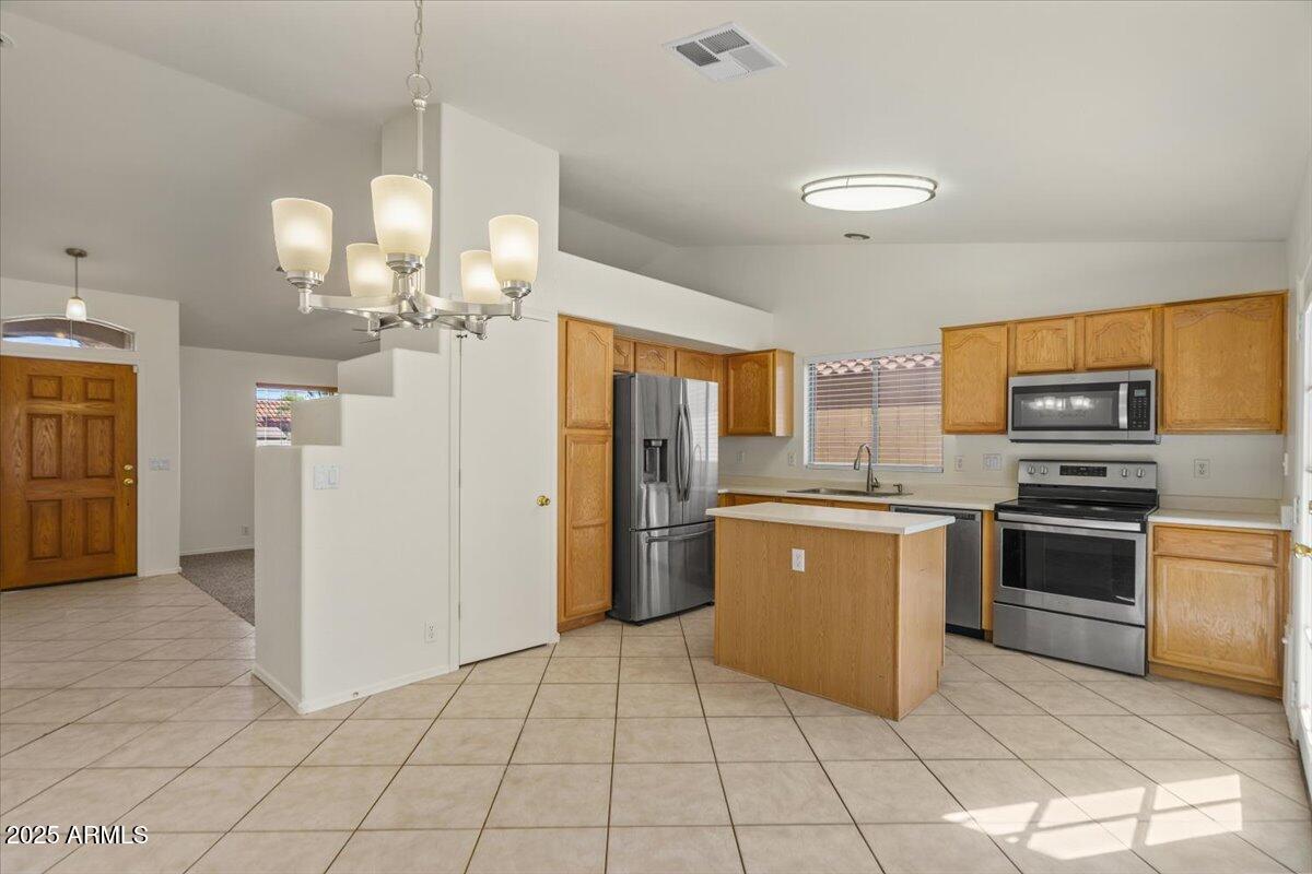 9163 West St John Road Peoria, AZ 85382 - Photo 14 of 38 a large kitchen with a refrigerator a stove top oven a sink and dishwasher