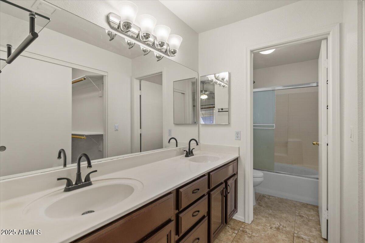 9163 West St John Road Peoria, AZ 85382 - Photo 21 of 38 a bathroom with a sink double vanity and a mirror