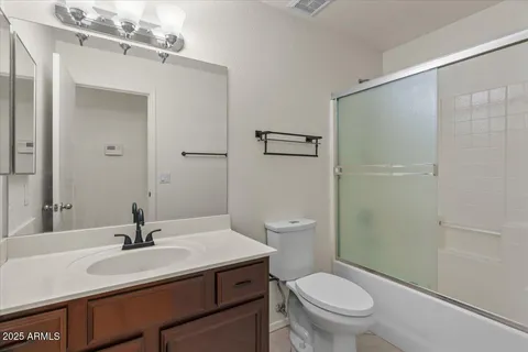 a bathroom with a sink toilet a mirror and shower