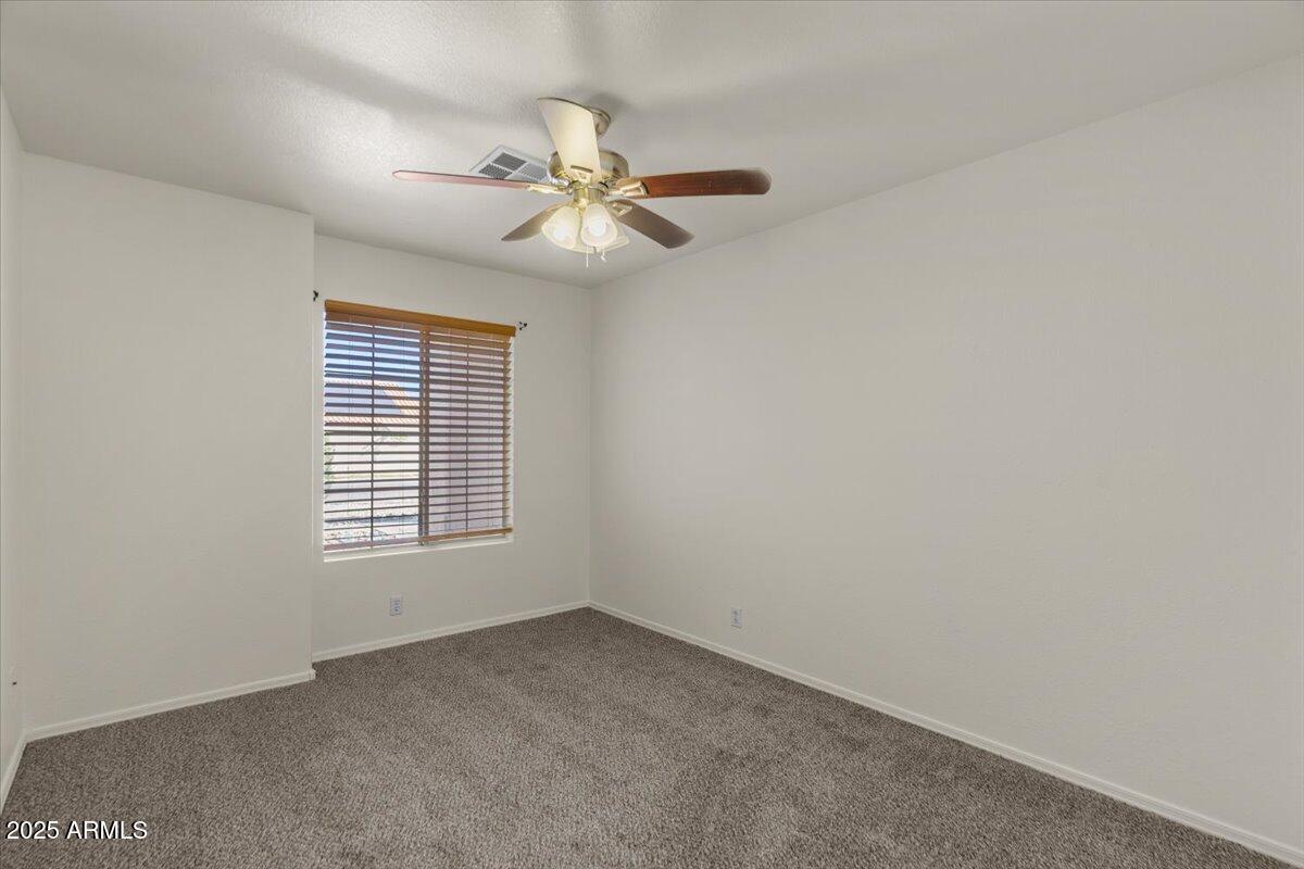 9163 West St John Road Peoria, AZ 85382 - Photo 26 of 38 an empty room with windows and fan