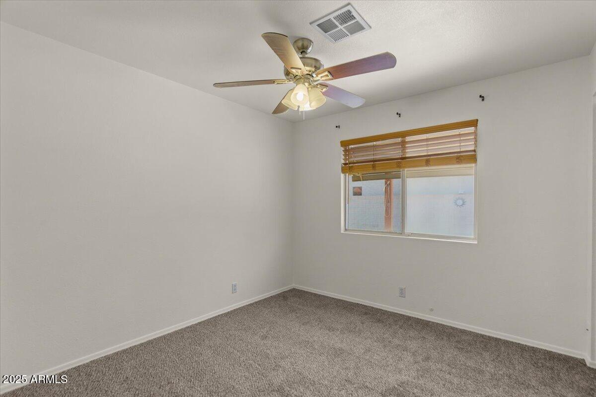 9163 West St John Road Peoria, AZ 85382 - Photo 28 of 38 an empty room with a window and ceiling fan