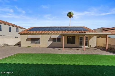 a front view of a house with a garden and yard