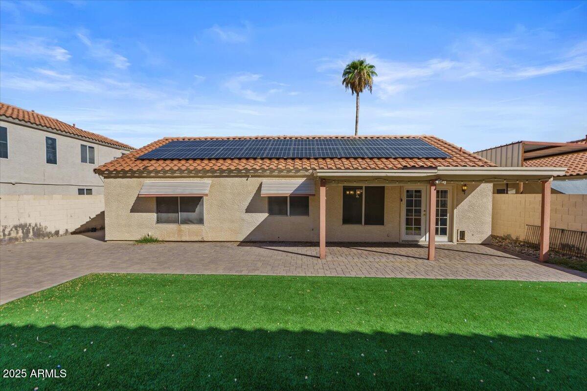 9163 West St John Road Peoria, AZ 85382 - Photo 32 of 38 a front view of a house with a garden and yard