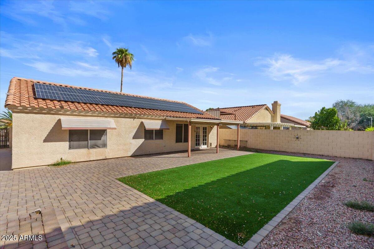 9163 West St John Road Peoria, AZ 85382 - Photo 34 of 38 a front view of a house with a garden and yard