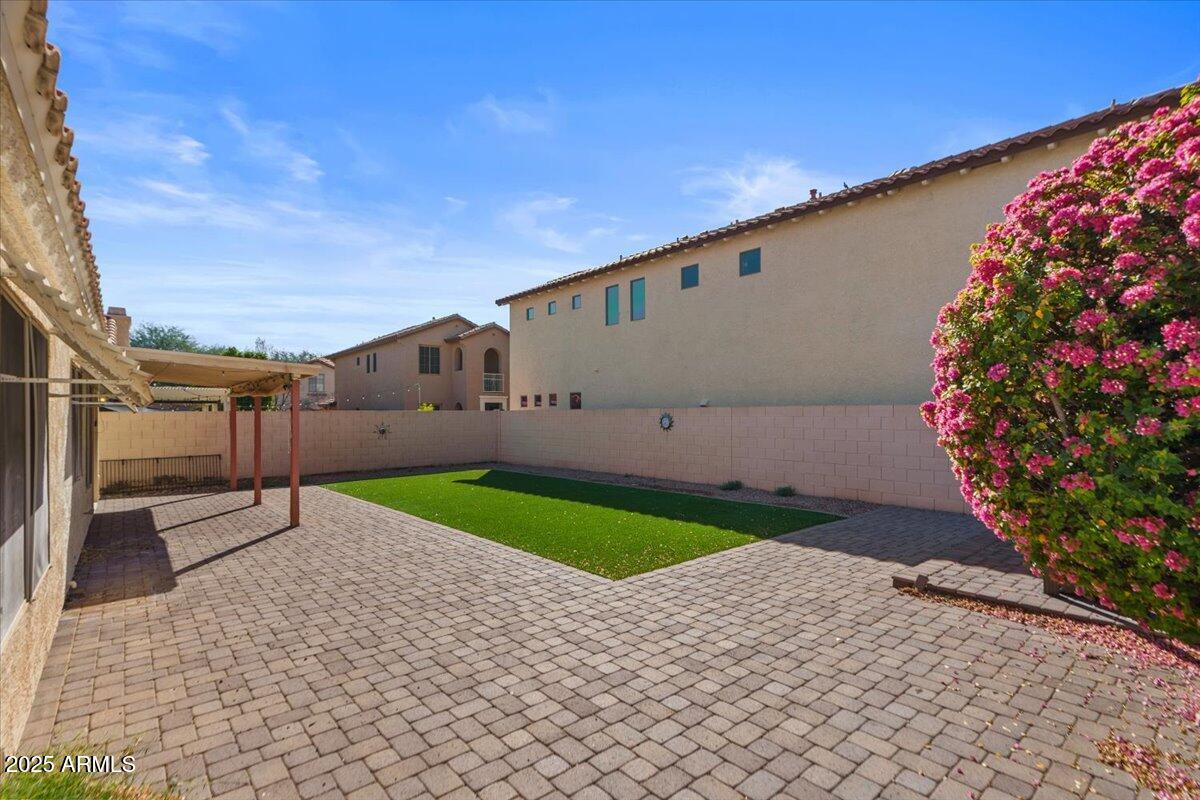 9163 West St John Road Peoria, AZ 85382 - Photo 35 of 38 a side view of a house and a yard
