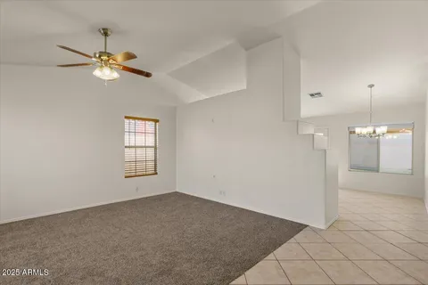 a living room with furniture a rug and a flat screen tv