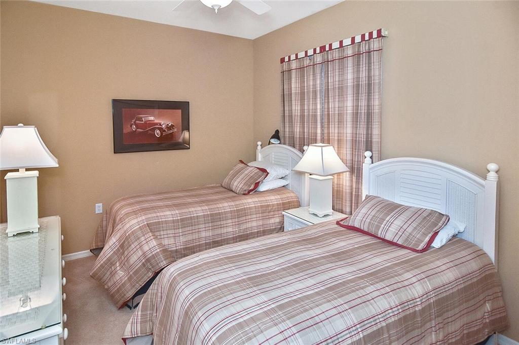 3830 Sawgrass Way, Unit 2946 Naples, FL 34112 - Photo 15 of 49 a bedroom with a bed and a lamp