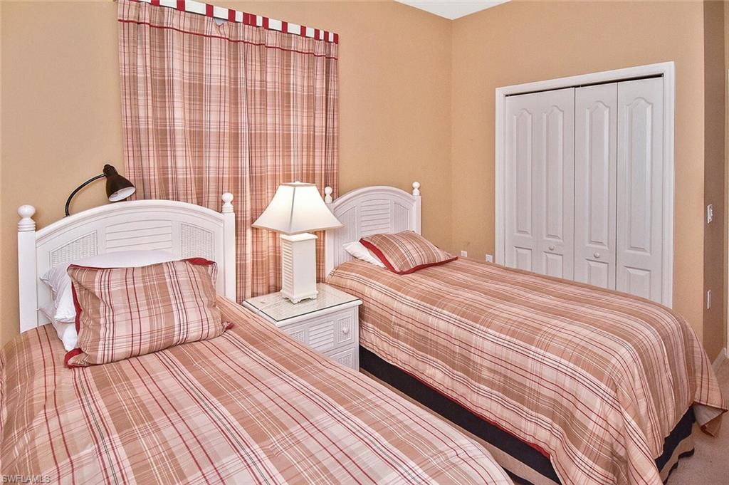 3830 Sawgrass Way, Unit 2946 Naples, FL 34112 - Photo 18 of 49 a bedroom with bed and wooden floor