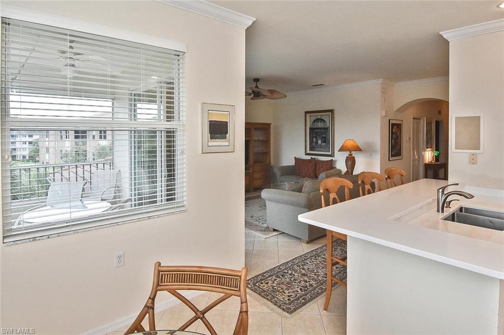 3830 Sawgrass Way, Unit 2946 Naples, FL 34112 - Photo 31 of 49 a living room with furniture and a large window