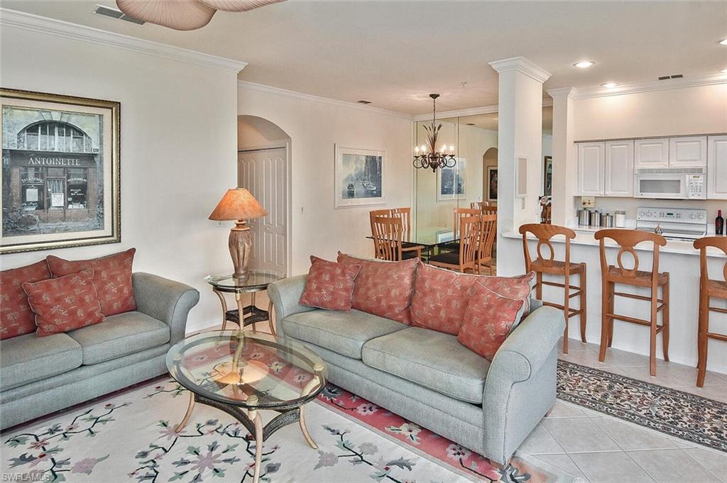 3830 Sawgrass Way, Unit 2946 Naples, FL 34112 - Photo 32 of 49 a living room with furniture and a dining table