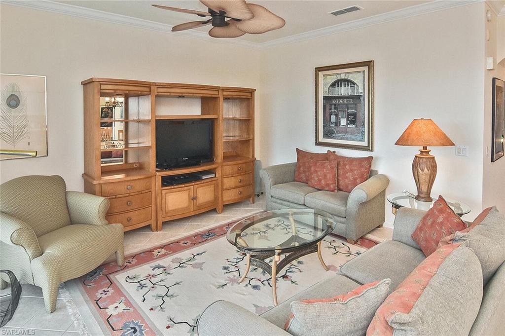 3830 Sawgrass Way, Unit 2946 Naples, FL 34112 - Photo 33 of 49 a living room with furniture a rug and a flat screen tv
