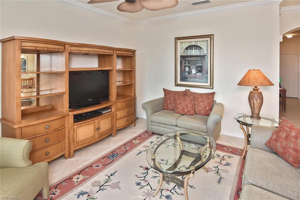 3830 Sawgrass Way, Unit 2946 Naples, FL 34112 - Photo 34 of 49 a living room with furniture and a flat screen tv