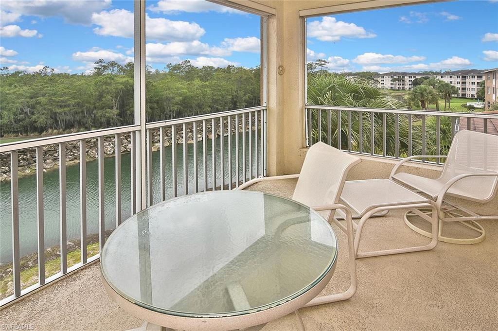 3830 Sawgrass Way, Unit 2946 Naples, FL 34112 - Photo 39 of 49 a balcony with table and chairs
