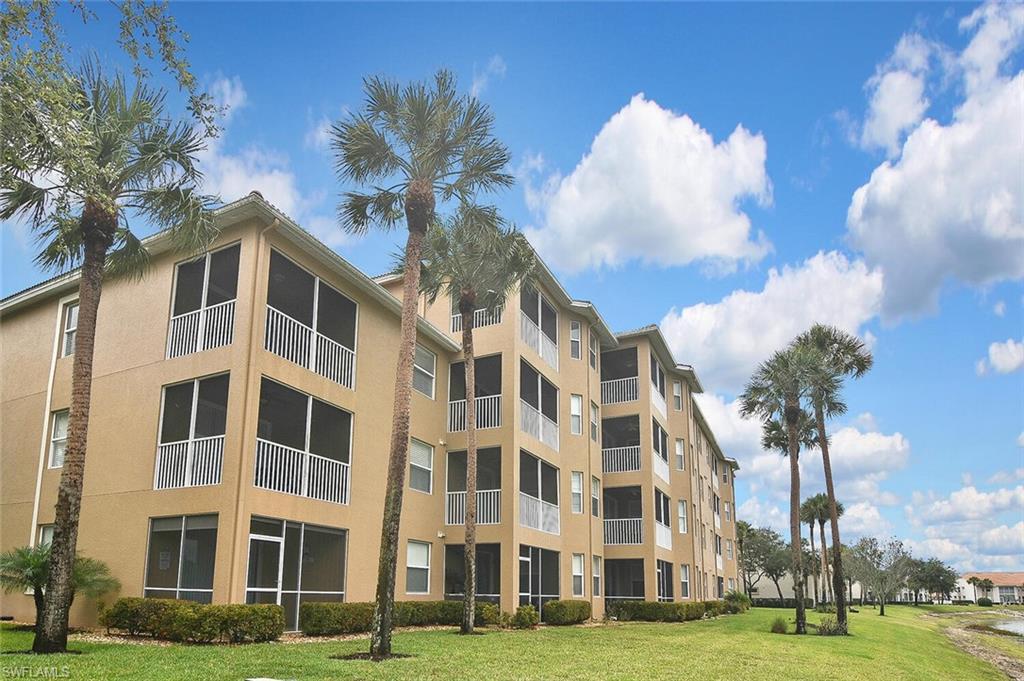 3830 Sawgrass Way, Unit 2946 Naples, FL 34112 - Photo 44 of 49 a view of a building with a yard