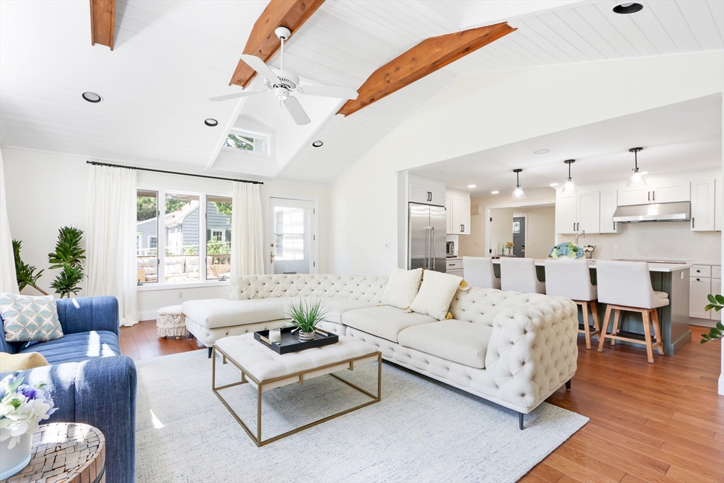 a living room with furniture white walls and wooden floor