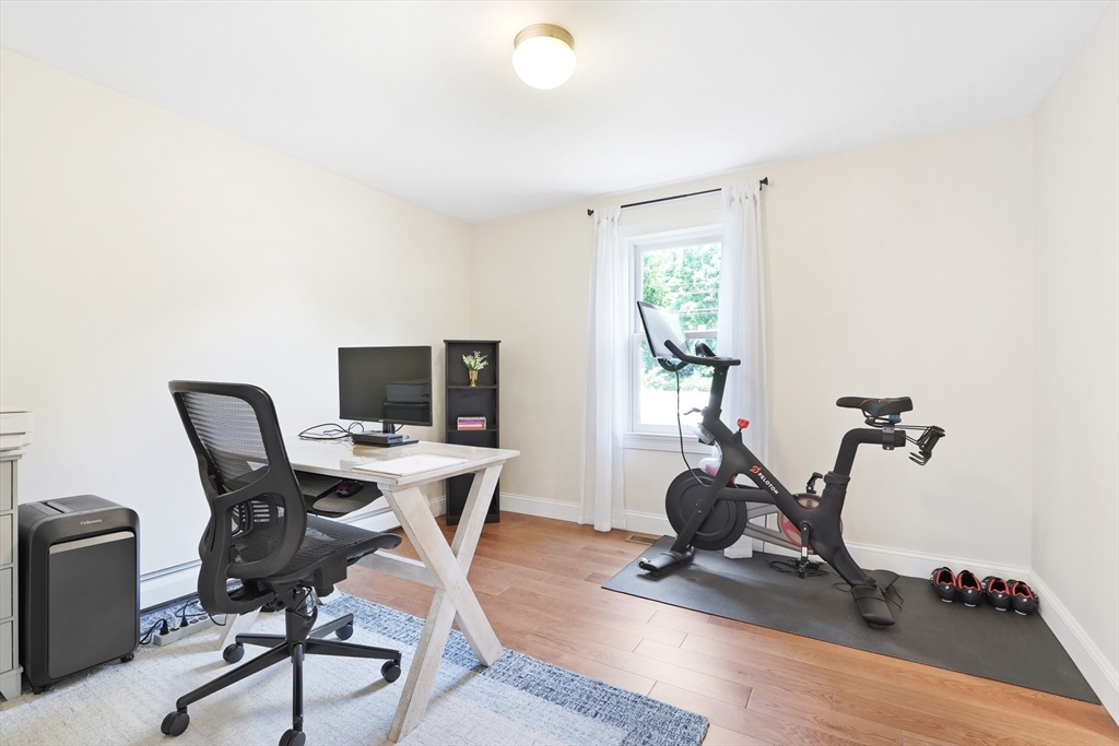 247 Greendale Avenue Needham, MA 02494 - Photo 14 of 33 a view of a workspace with furniture and a gym cycle