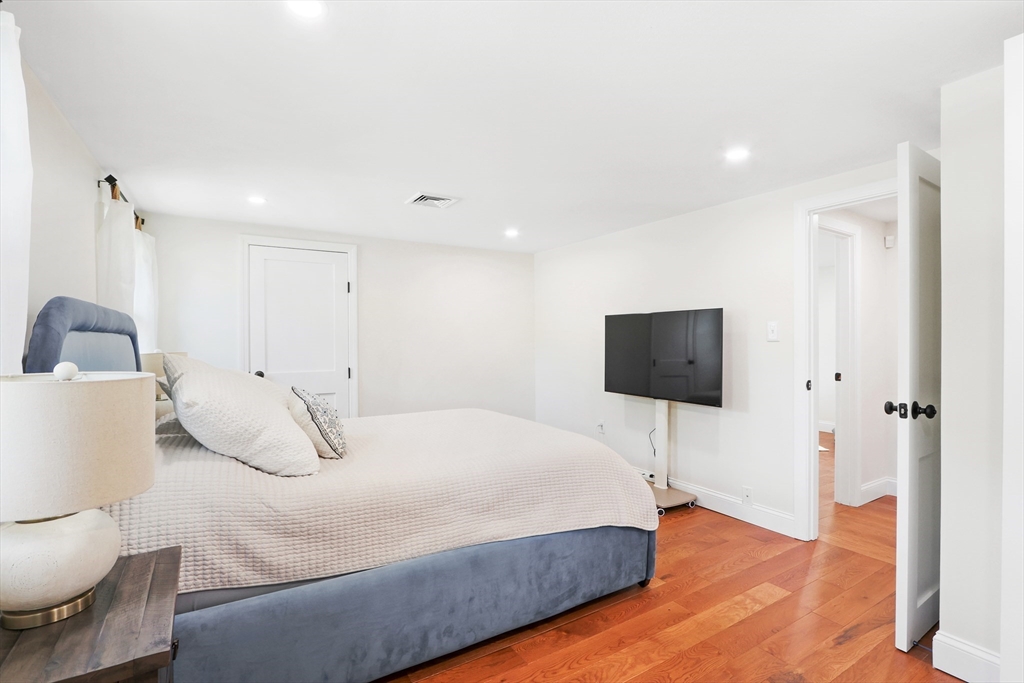 247 Greendale Avenue Needham, MA 02494 - Photo 17 of 33 a bedroom with a bed and a flat screen tv