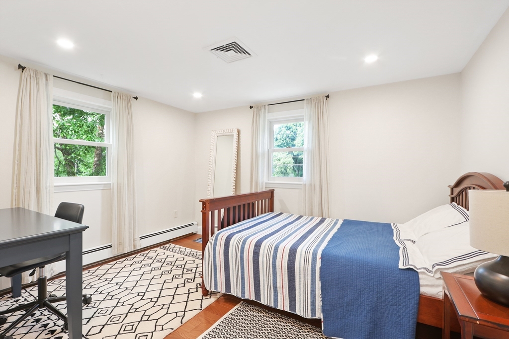 247 Greendale Avenue Needham, MA 02494 - Photo 21 of 33 a bedroom with a bed and wooden floor