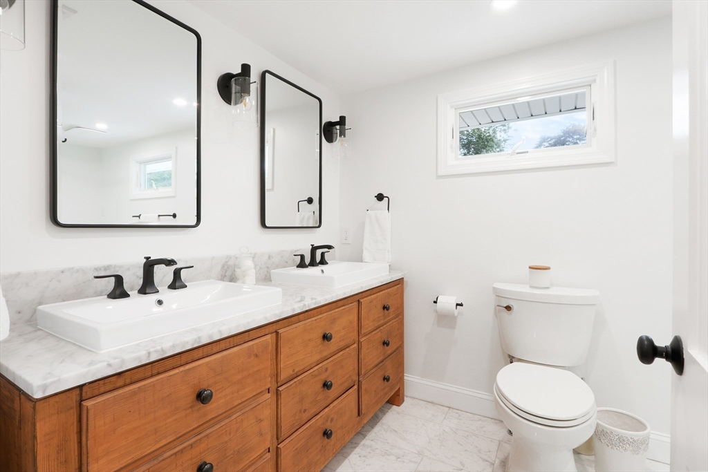 247 Greendale Avenue Needham, MA 02494 - Photo 22 of 33 a bathroom with a toilet sink and mirror